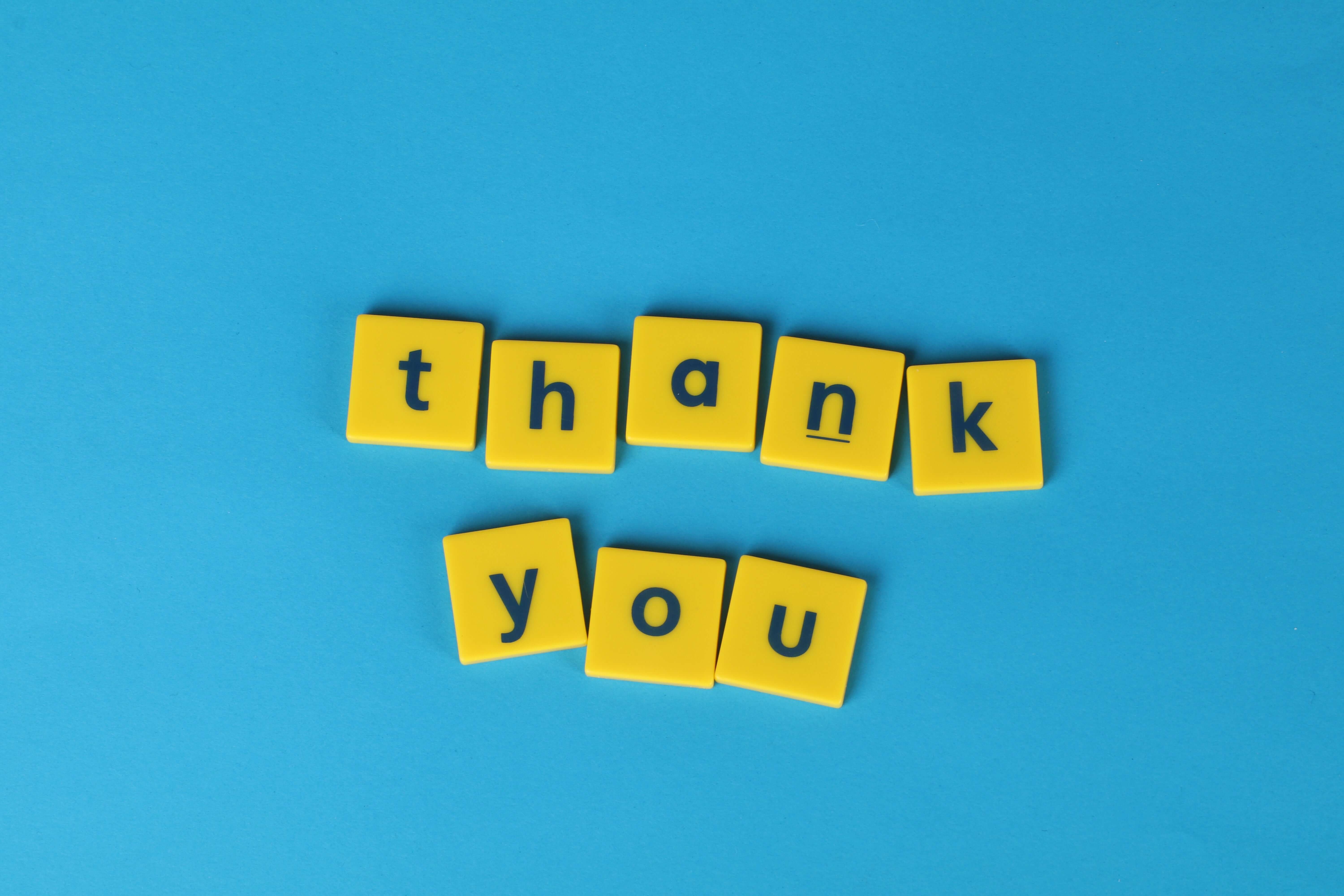 thank you yellow letters on a blue background