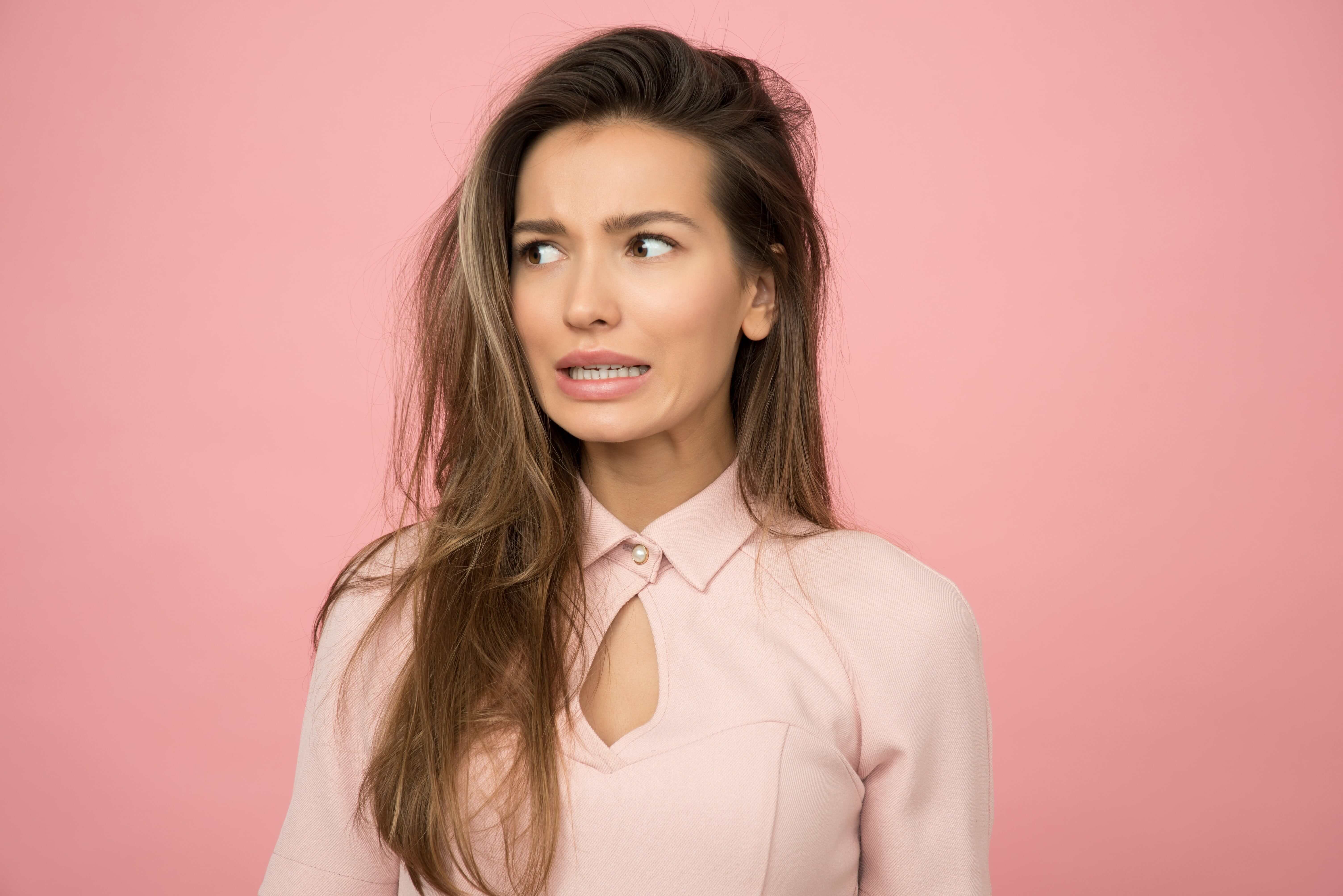 Woman Concerned and Wearing Pink Top