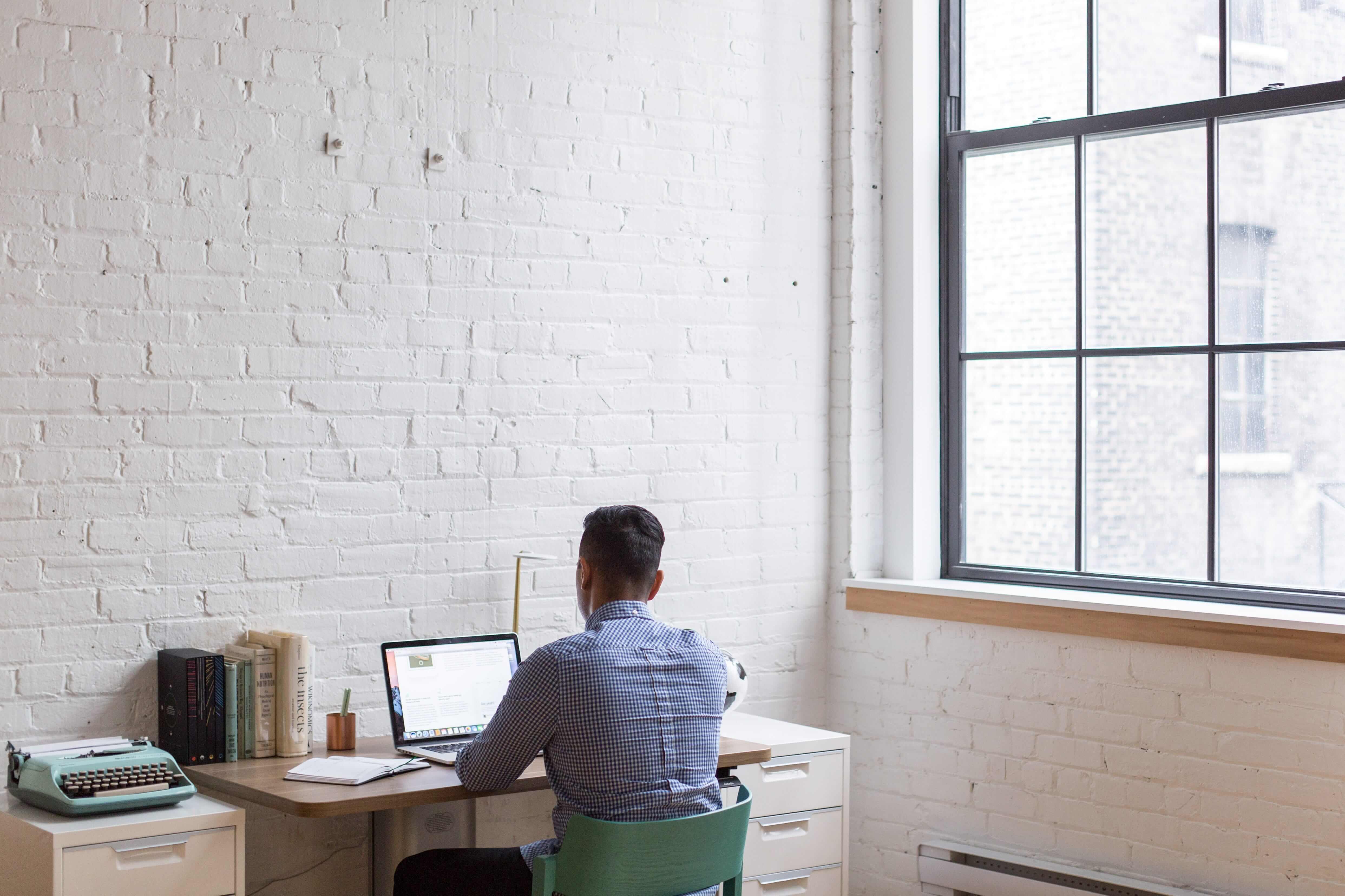 Man sitting alone and using a laptop