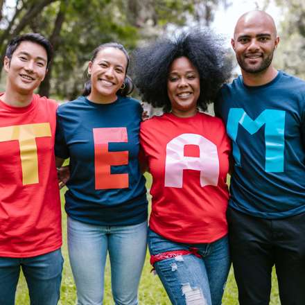 group of colleagues with the words team on their shirts