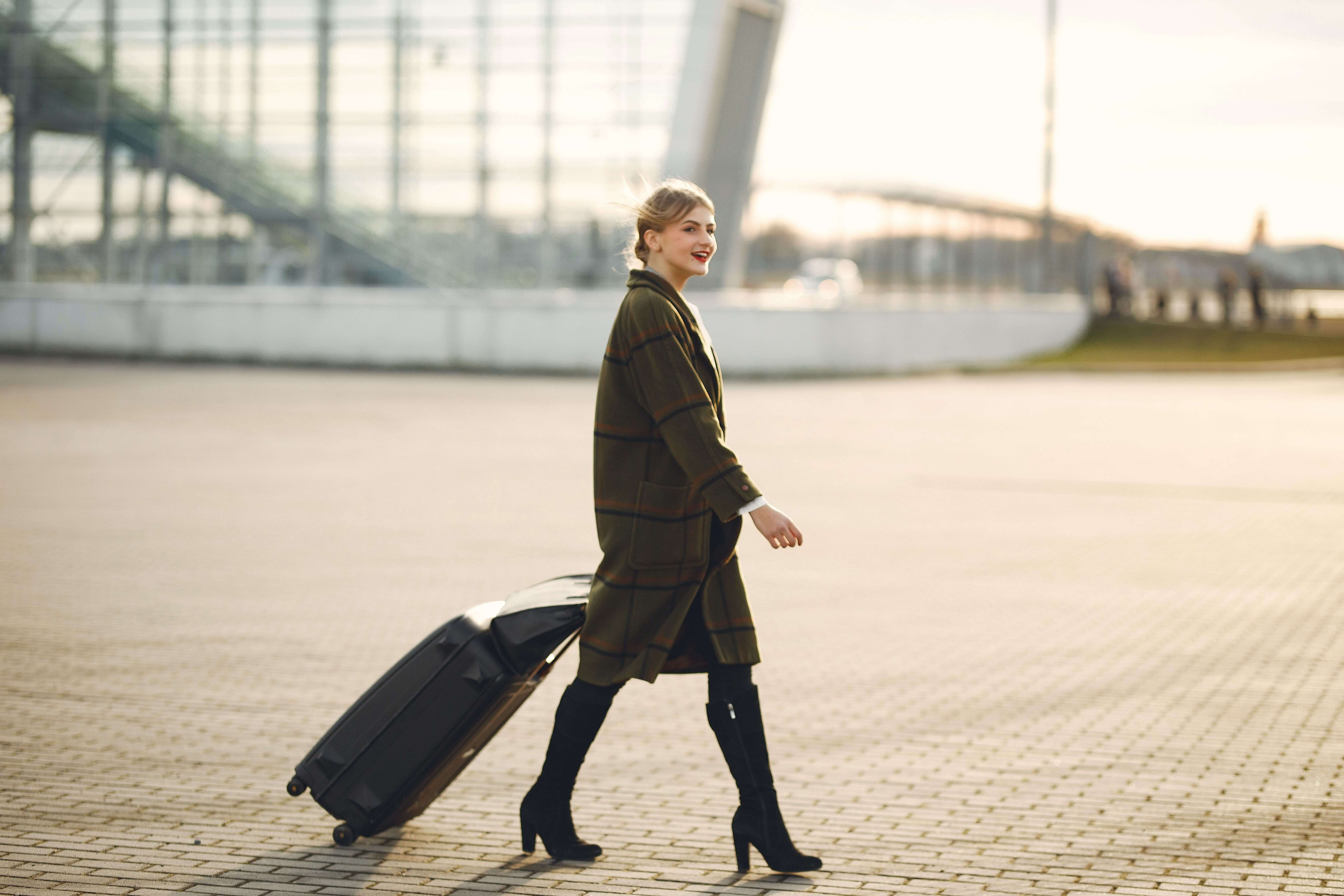 Young Woman With Suitcase Walking