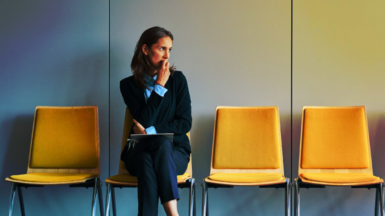 Stressful young woman waiting for job interview.