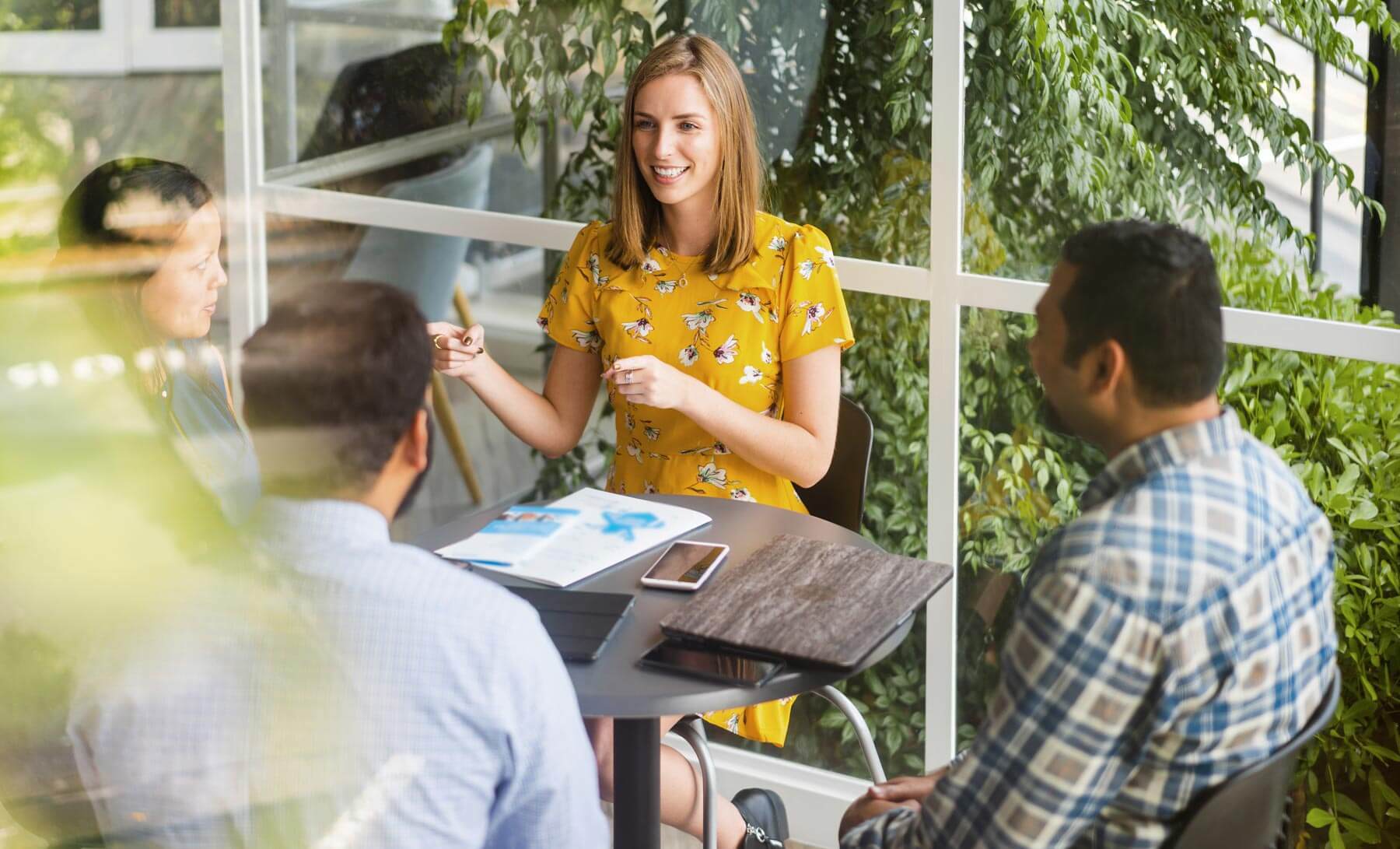 Confident woman taking lead role in business meeting.