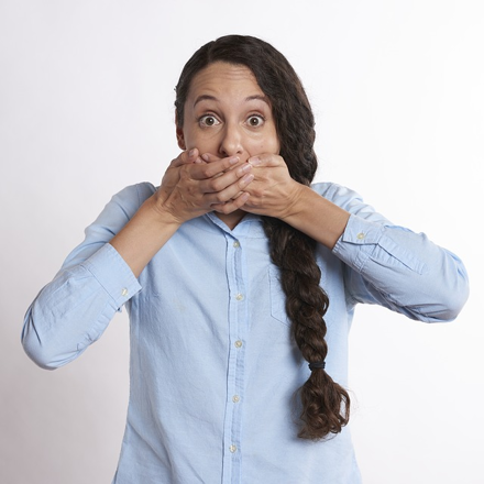 Woman covering mouth in shock