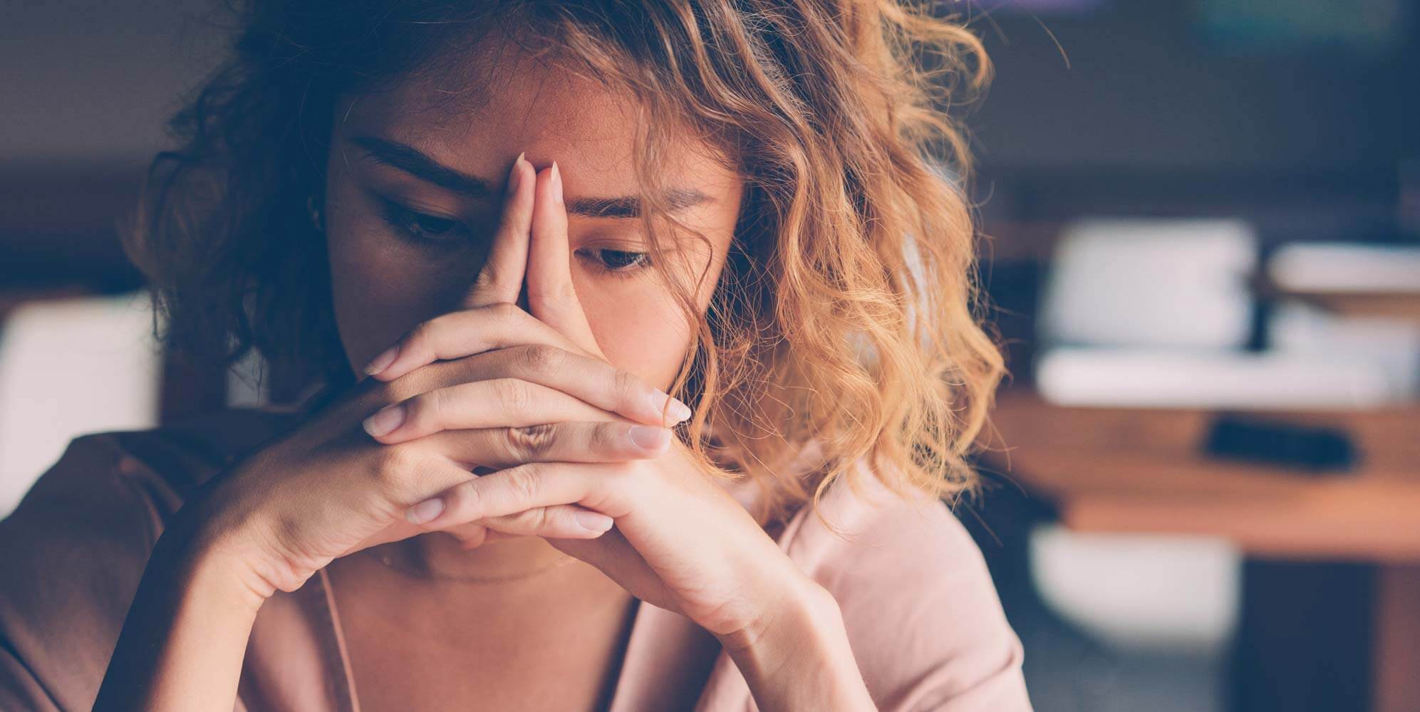 Tired Young Woman Leaning Head on Hands