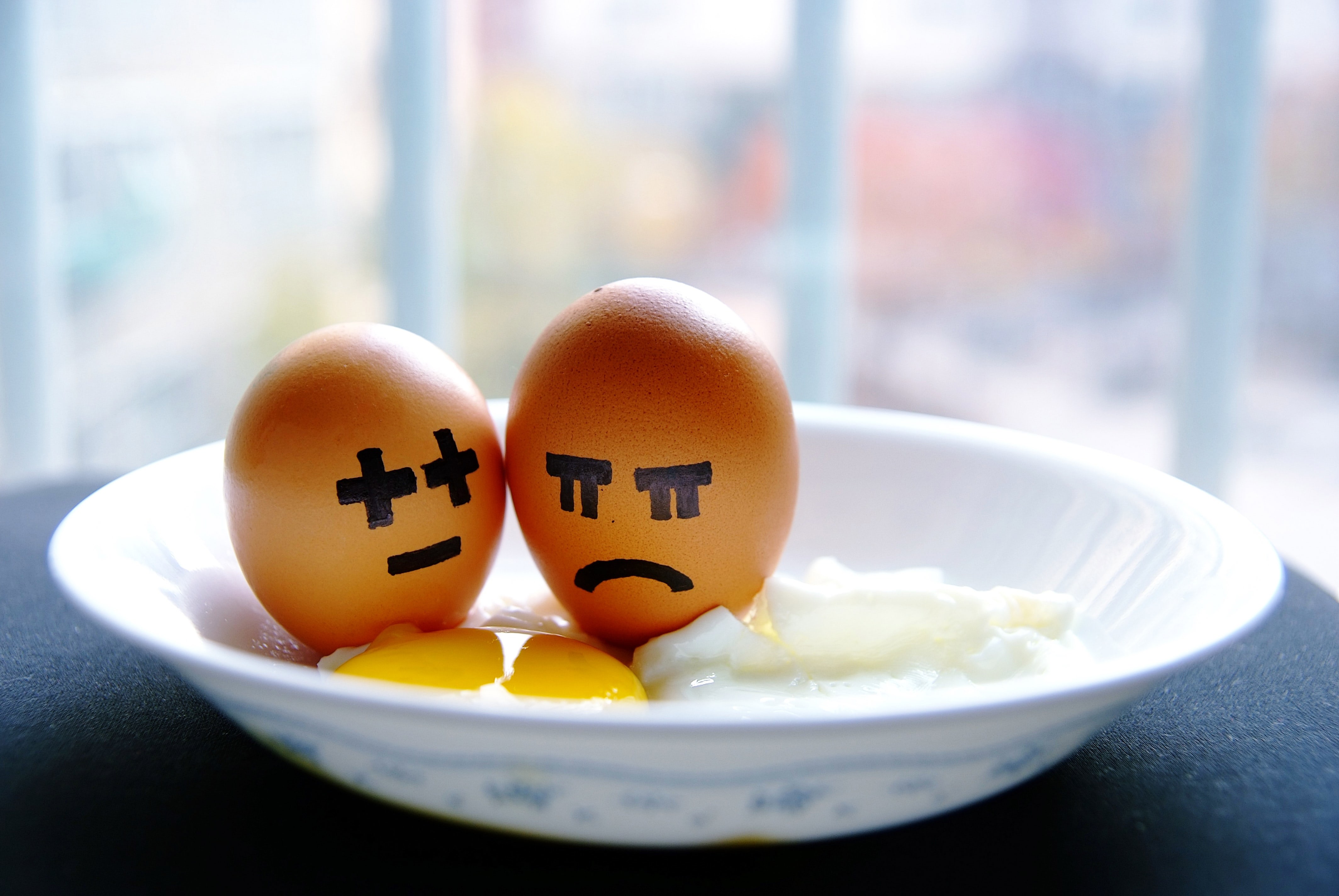 Neutral and unhappy faces painted on some egg shells